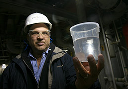 Poet BigRefining's General Manager Dave Hudak holds a cup of 200-proof alcohol.