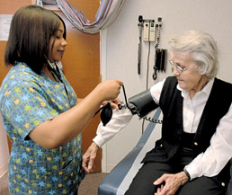 St. Vincent nurse Carmen Cotham checks Betty Young's blood pressure.