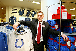 Manager at Macy's shows off local Colts gear.