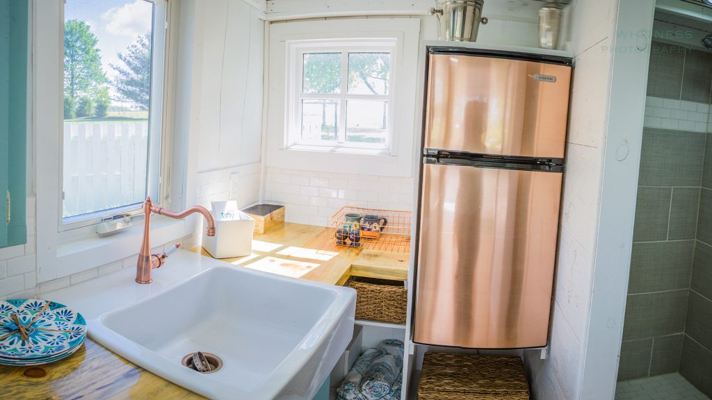 The kitchen has a surprising amount of counter space and a larger sink. An apartment-size refrigerator and two-burner stove round out the space.