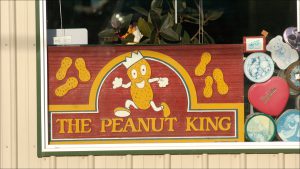A vintage Peanut King sign in Richard Green Co.'s window. The Indianapolis company got its start in 1957 selling peanut vending machines.