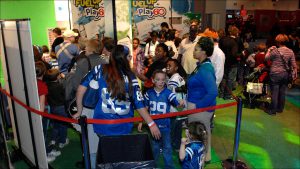 Record attendance was expected at the NFL Experience, where visitors lined up to have their picture taken in football gear.